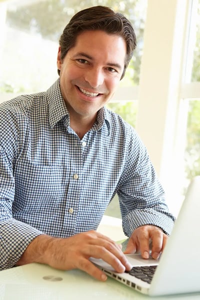 man smiling looking at the digital marketing strategy services offered by RDM on his computer