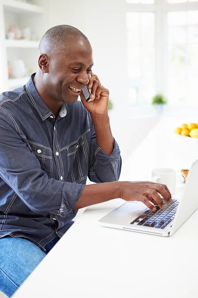 man looking at seo consulting services for his local business on the computer while smiling