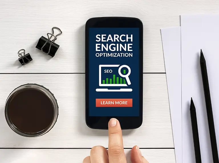 search engine optimization displayed on a website on a phone with a button to learn more