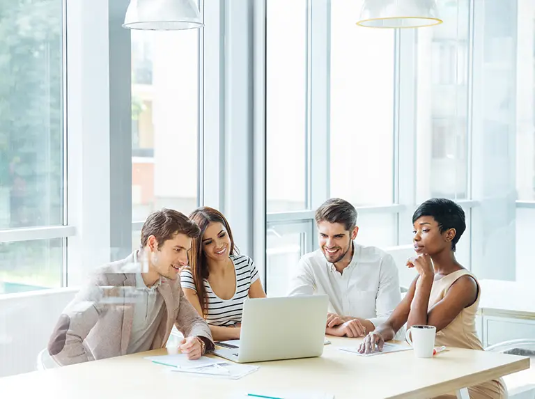 digital marketing strategy being discussed by 4 person business team sitting around a table